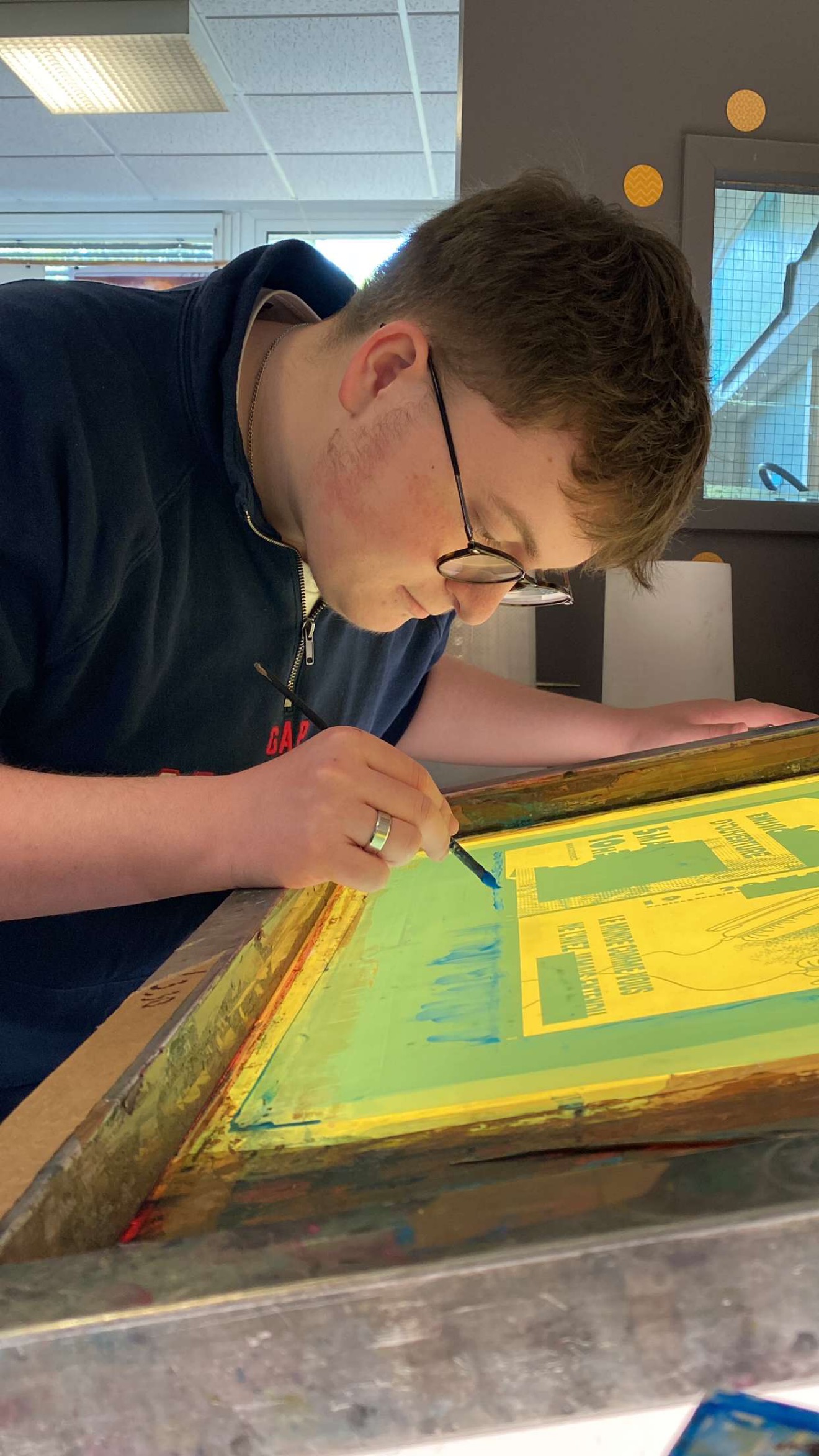 Florian Cueff, graphiste 3ZEF, réalisant une sérigraphie dans son atelier